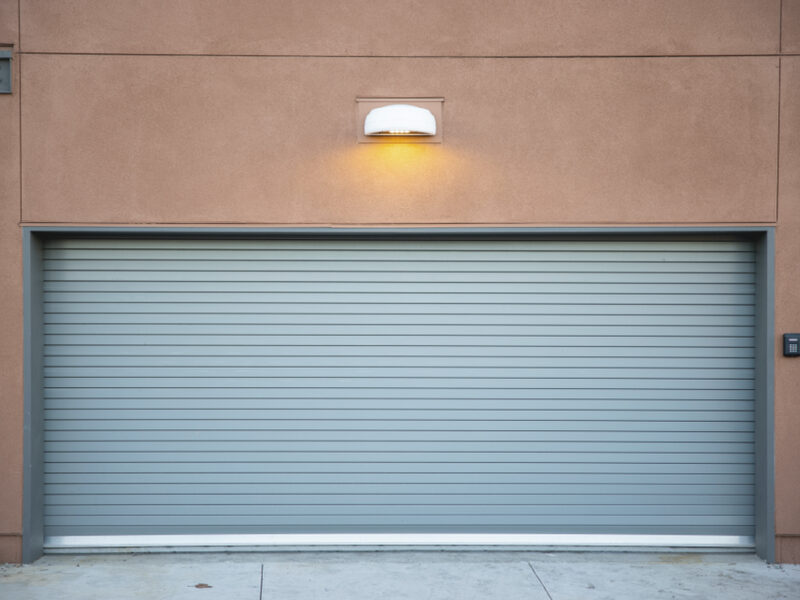 A modern roll-up garage door with a keypad